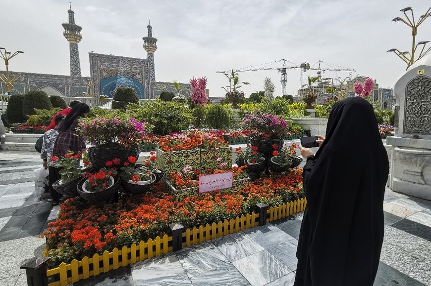 Iranians visit the spot in the courtyard of Imam Reza shrine in the northeastern city of Mashhad on April 6, 2022, where a day earlier a Muslim cleric was stabbed to death
