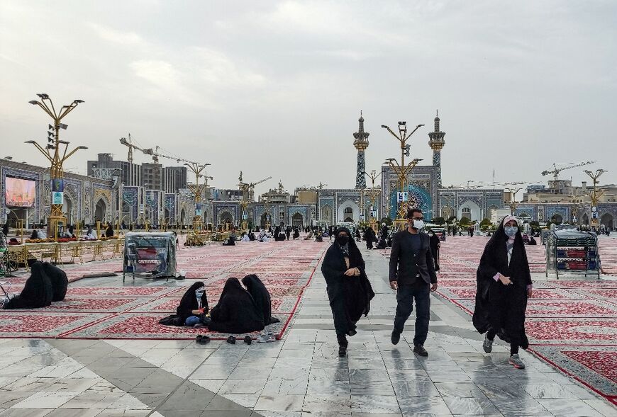 Shiite Muslim worshippers walk through the courtyard of Imam Reza shrine in the northeastern Iranian city of Mashhad on April 5, 2022