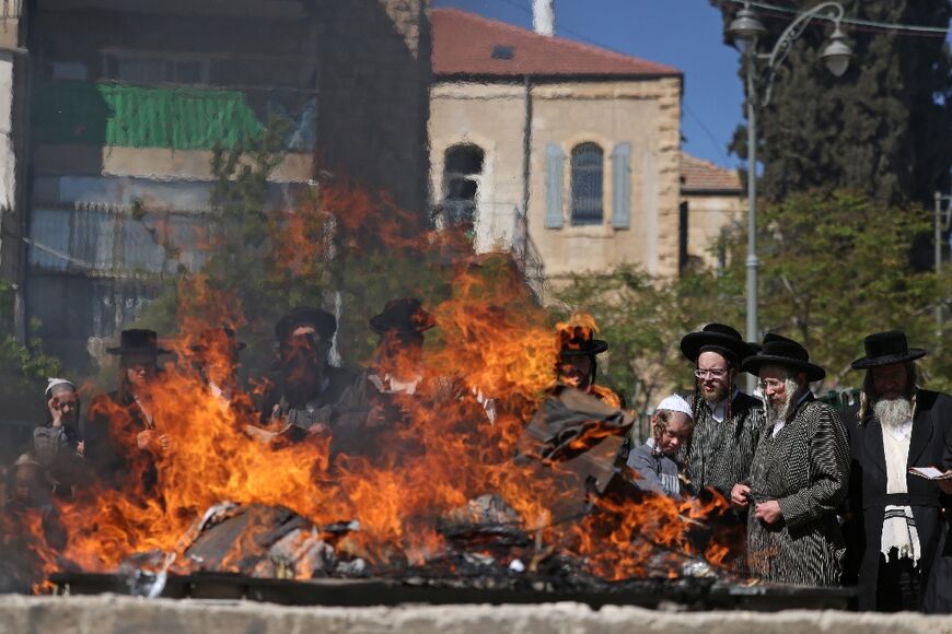Ultra-Orthodox Jewish men burn leavened items during the Biur Chametz ritual on April 15, 2022 in Jerusalem, before Passover