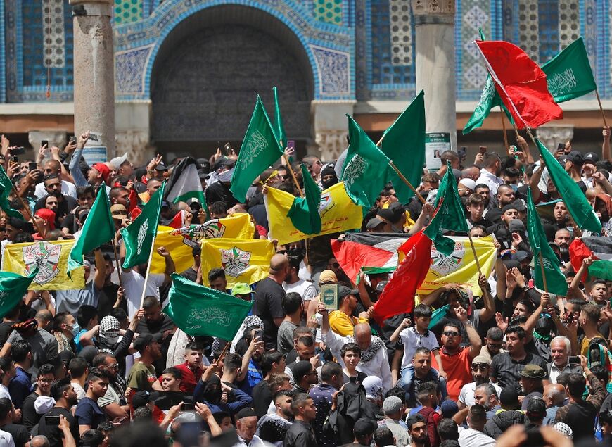 Palestinian protesters rally by the Dome of the Rock mosque at the Al-Aqsa Mosque complex in Jerusalem following the last Friday prayers of the Muslim holy month of Ramadan