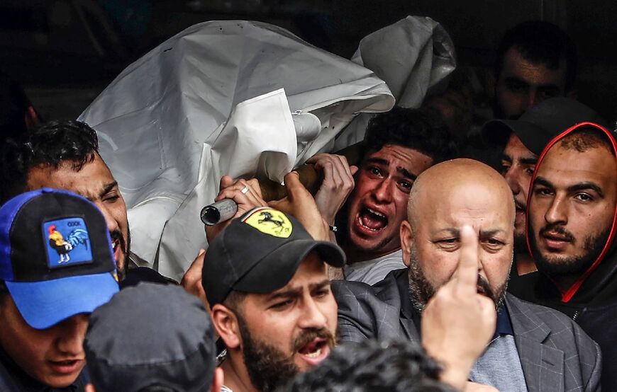 Mourners carry the corpse of one of the people who died when their boat capsized off Tripoli in northern Lebanon 