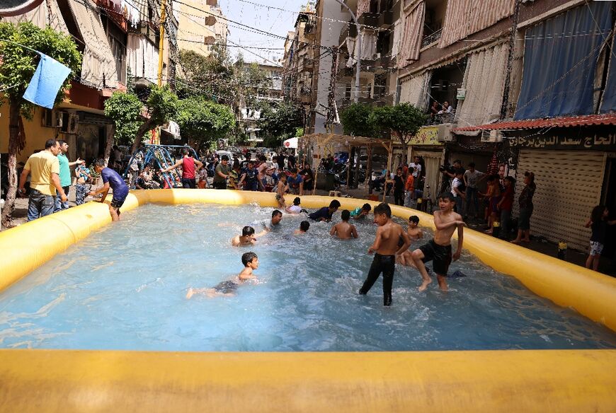 Children play in an inflatable swimming pool installed by supporters of former Lebanese prime minister Saad Hariri, who have boycotted the parliamentary elections