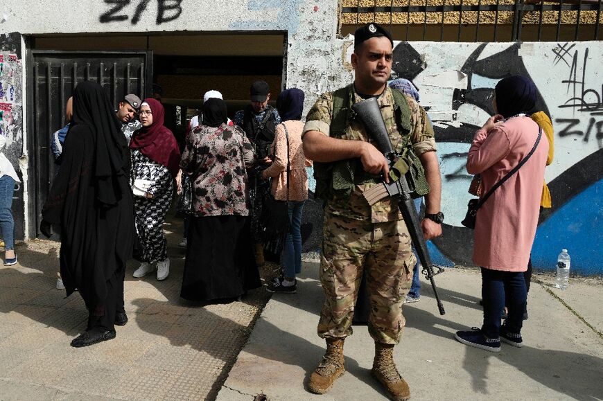 Voters queue to cast their ballot in the parliamentary election at a polling station in the northern Lebanese city of Tripoli, on May 15, 2022