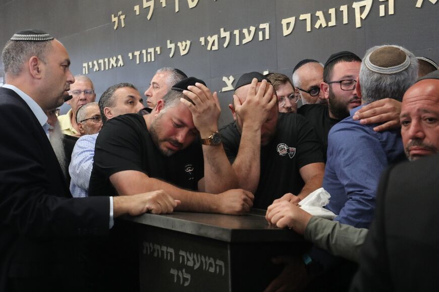 Relatives and friends mourn on May 6 at a cemetery in Lod during the funeral of Oren Ben Yiftach, a 35-year-old Israeli who was killed in an axe attack the night before in Elad
