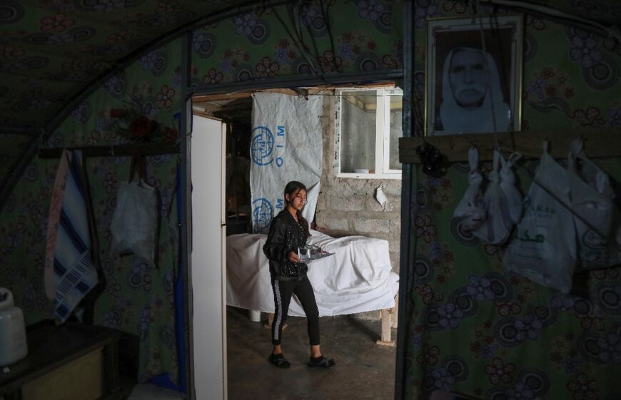 A displaced Yazidi girl walks in a tent at the Chamishko camp in the city of Zakho, where members of the community fled after a recent surge in violence