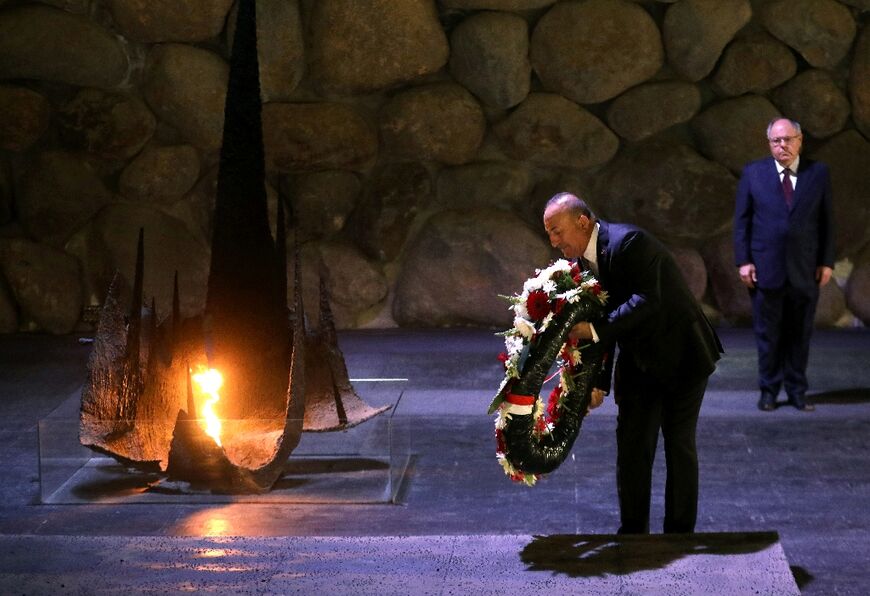 Mevlut Cavusoglu lays a wreath by the eternal flame at the Hall of Remembrance at the Yad Vashem Centre in Jerusalem