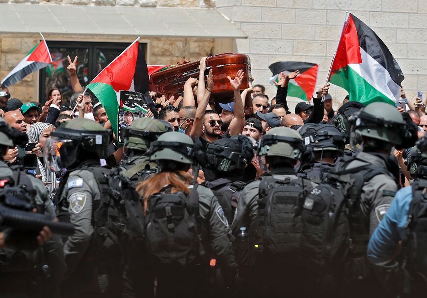 Israeli security forces confront Palestinian mourners carrying the casket of slain Al Jazeera journalist Shireen Abu Akleh in east Jerusalem on May 13, 2022