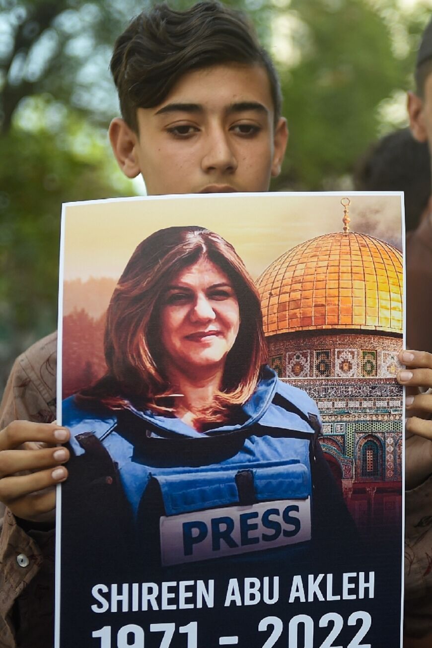 Slain journalist Shireen Abu Akleh seen on a poster held at a rally in Karachi, Pakistan by the Supporters of Palestine Foundation Pakistan, on May 15, 2022 