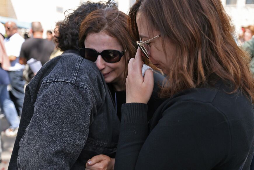Mourners react as the body of veteran Al Jazeera journalist Shireen Abu Akleh arrives in the east Jerusalem neighbourhood of Sheikh Jarrah on May 12