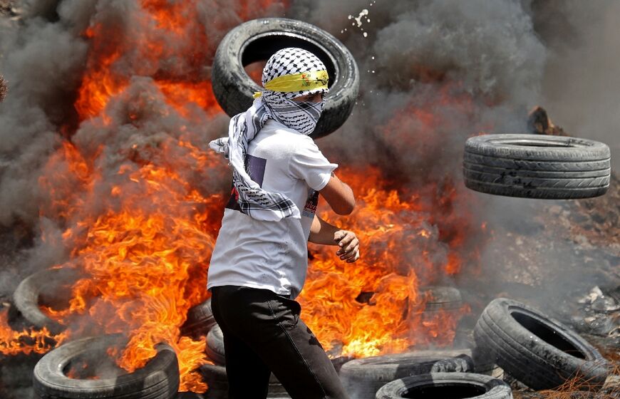 Palestinian protesters burn tyres during clashes with Israeli security forces following a demonstration against Israel's expropriation of land, in the village of Kfar Qaddum near the Jewish settlement of Kedumim, in the occupied West Bank May 6, 2022