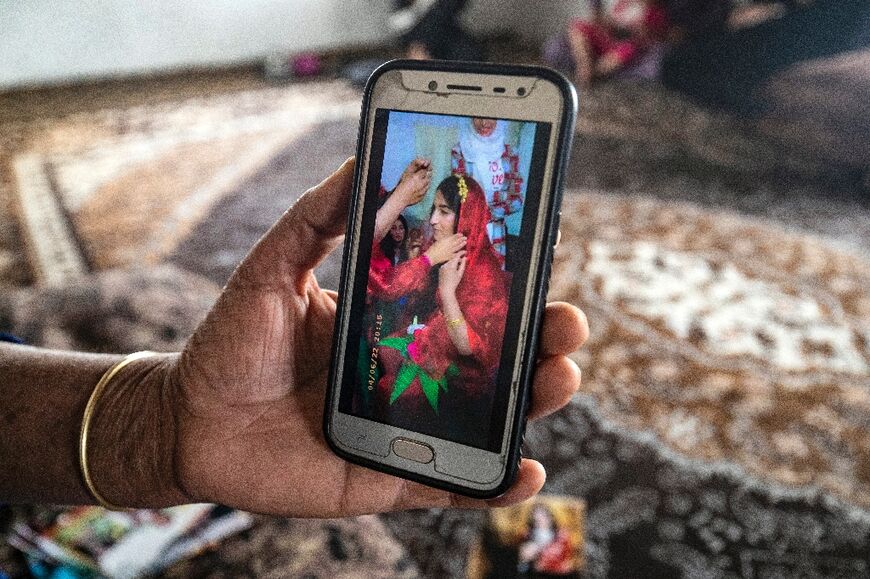 Jenda Saeed, pictured on a phone held by her mother, left her home in war-ravaged northeastern Syria in hopes of reaching her fiance in Germany