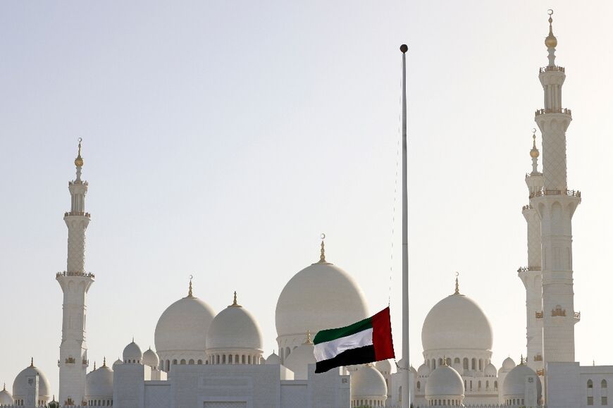 The United Arab Emirates flag flies at half-mast outside the Sheikh Zayed Grand Mosque in Abu Dhabi 
