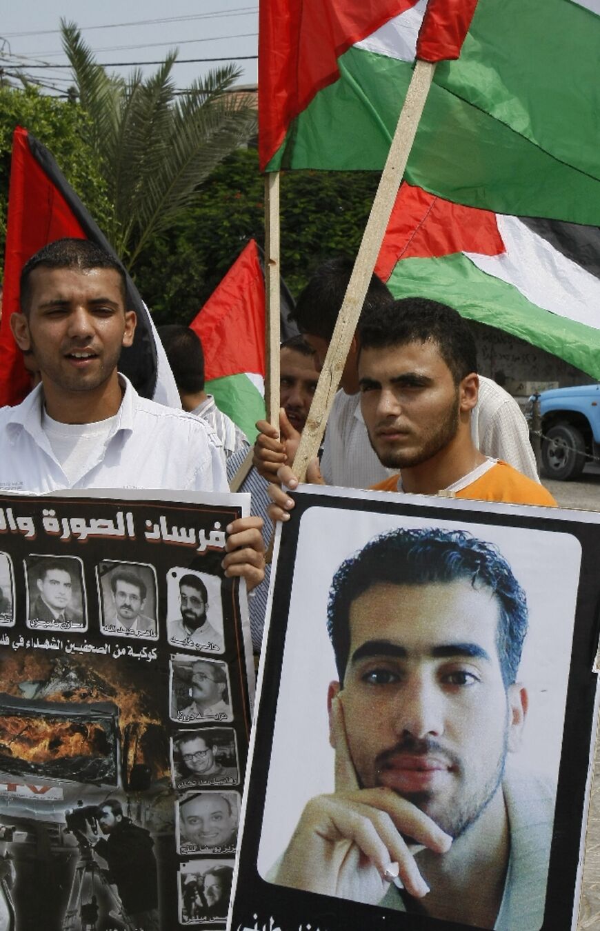 Palestinian journalists hold posters of Reuters cameraman Fadel Shana, who was killed on April 16, 2008 while covering clashes between Gaza militants and Israeli troops