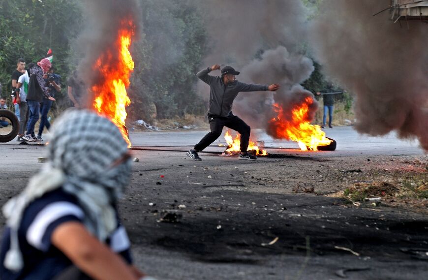 A Palestinian protester uses a slingshot to hurl stones during clashes with Israeli forces near Ramallah in the occupied West Bank on May 29