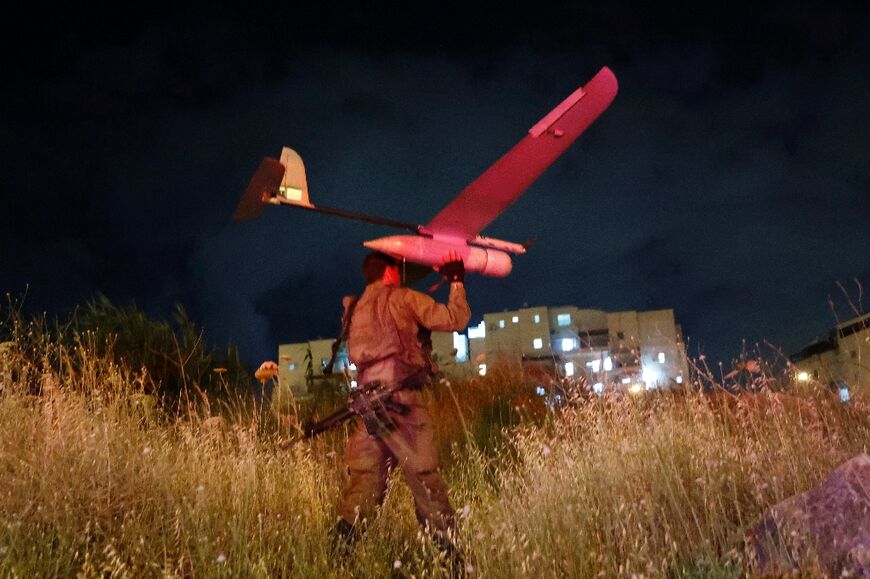 Israeli forces fly a drone to find suspects in the attack which killed three