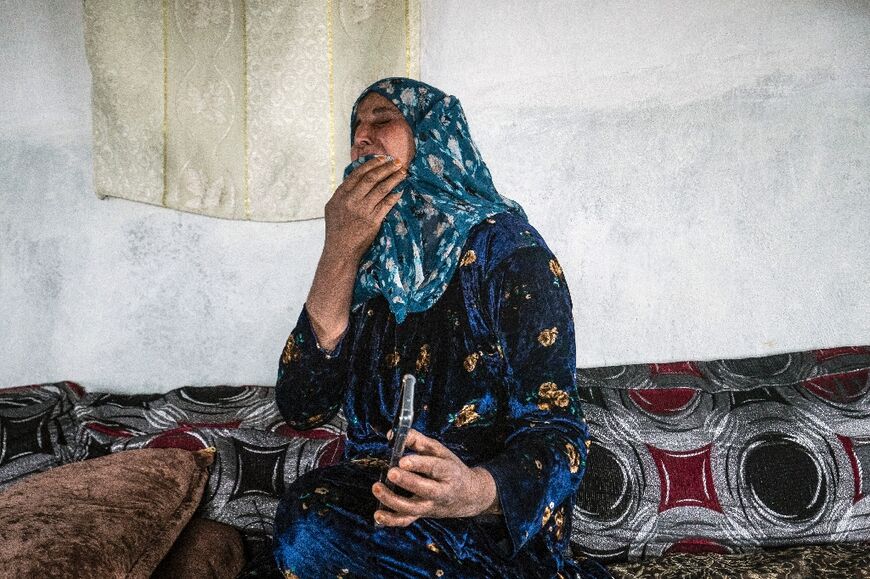 Shawafa Khodr reacts in grief as she holds a phone with a photograph of her missing daughter Jenda Saeed, who carried her mother's scarf so that I can protect her,' Khodr said