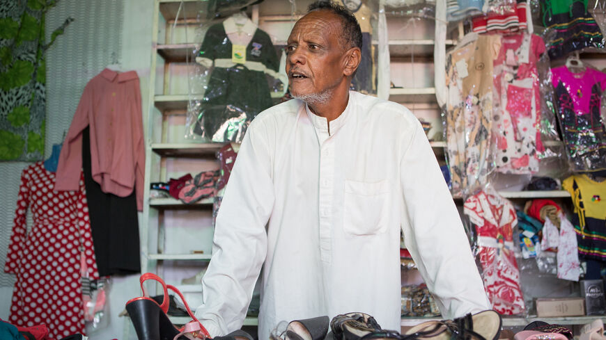 Portrait of Yousif Alhaj Ali, 56. After 37 years working as a plumbing supervisor for Abu Dhabi Municipality, he ​​opened a clothing shop in his native village, Tannoob.