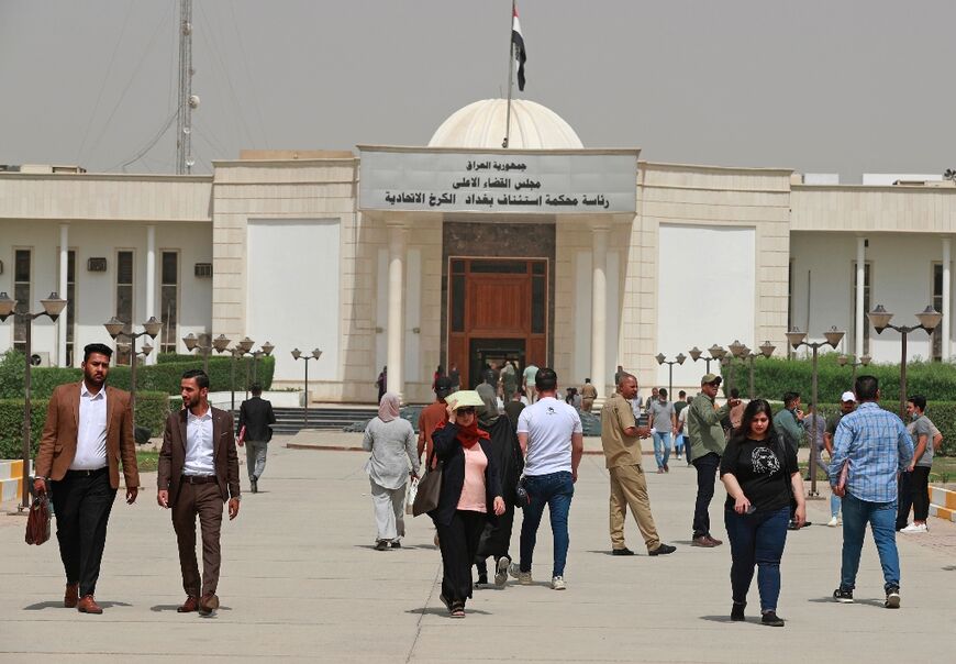 People walk outside Baghdad's Karkh Appeal Court on June 6, 2022