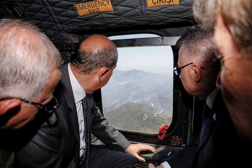 Turkish Cypriot leader Ersin Tatar (centre-left) and Turkey's Vice President Fuat Oktay (centre-right) inspect the wildfire from a helicopter