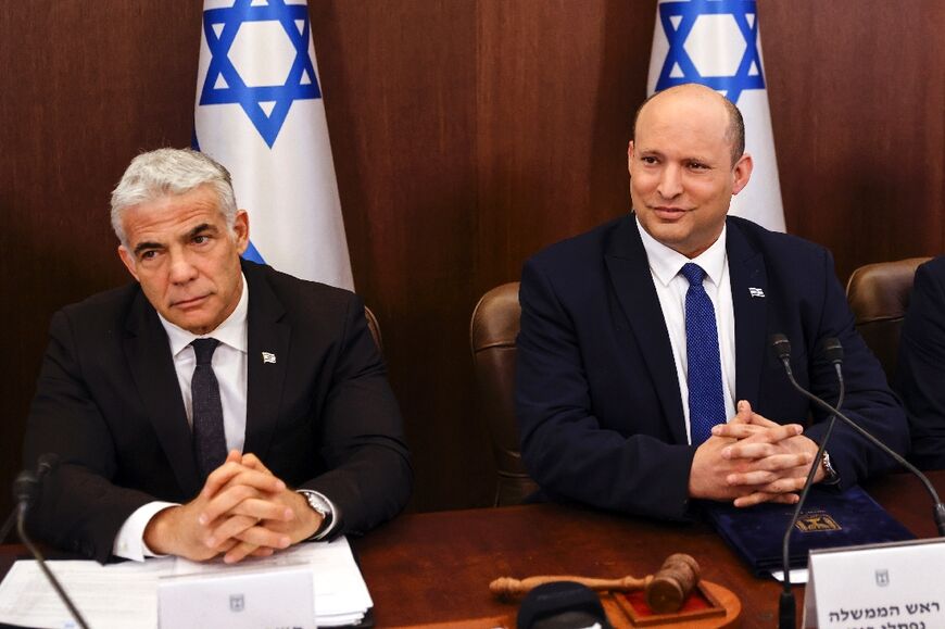 Israeli Prime Minister Naftali Bennett (R) and  Foreign Minister Yair Lapid attend a cabinet meeting ahead of parliament's expected dissolution 