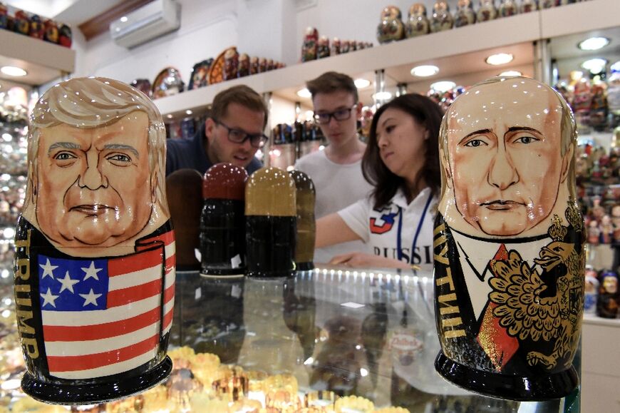 Traditional Russian wooden nesting dolls depicting former US President Donald Trump (L) and Russia's President Vladimir Putin (R)