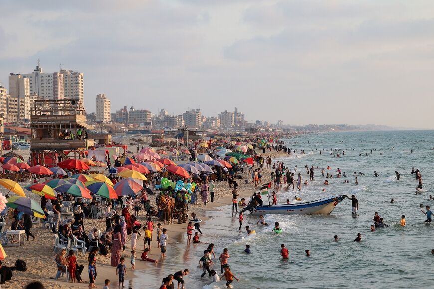 Palestinians flock to the beach after authorities lifted a warning about hazardous pollution
