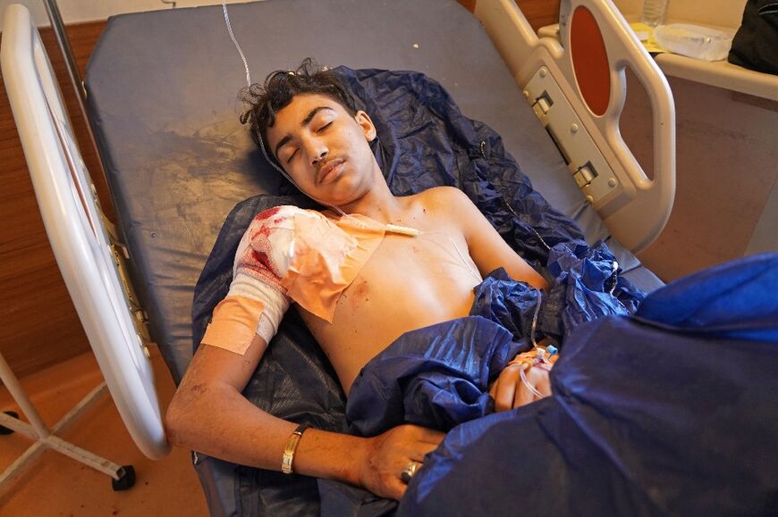 An injured man lies on a hospital bed following the shelling on Wednesday