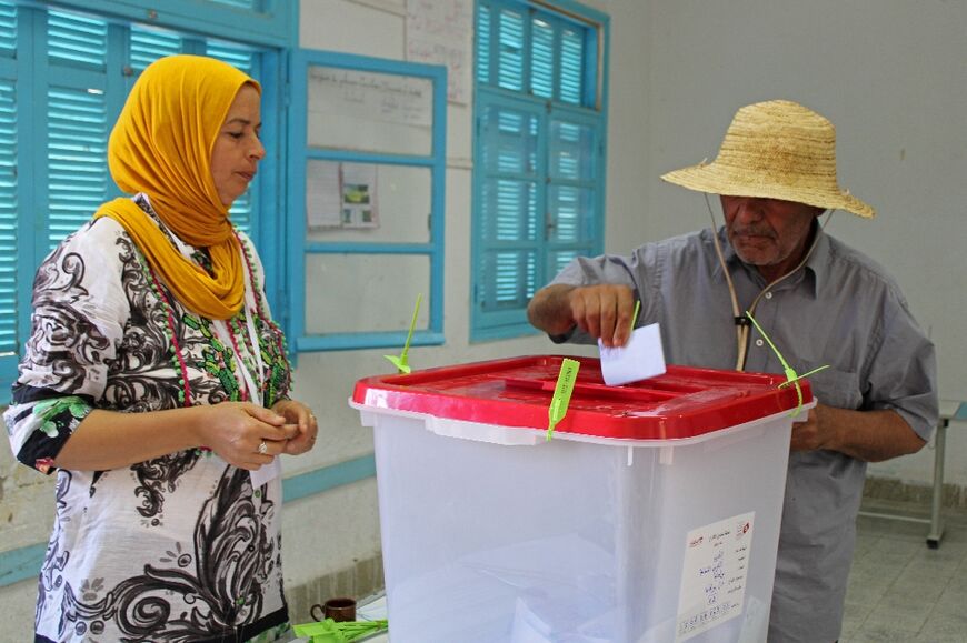 A Tunisian man votes at a polling station in Kasserine