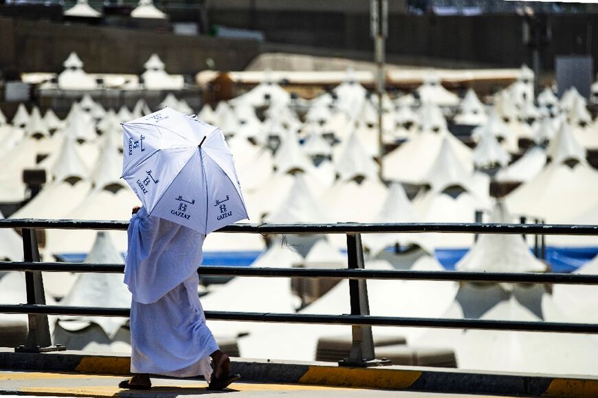 A Muslim pilgrim walks past the air-conditioned tents at the camp in Mina 