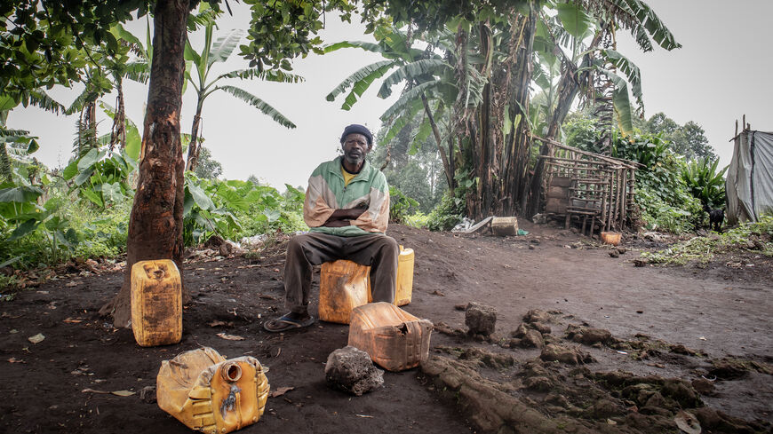 Nyandu Kifaka, aged 75, sits on an empty jerry-can in his compound in Rusayo, north of the city of Goma, Oct. 14, 2021. (Guerchom Ndebo)