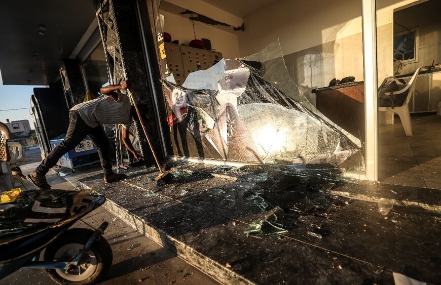 A Palestinian man inspects the damage following the Israeli raid