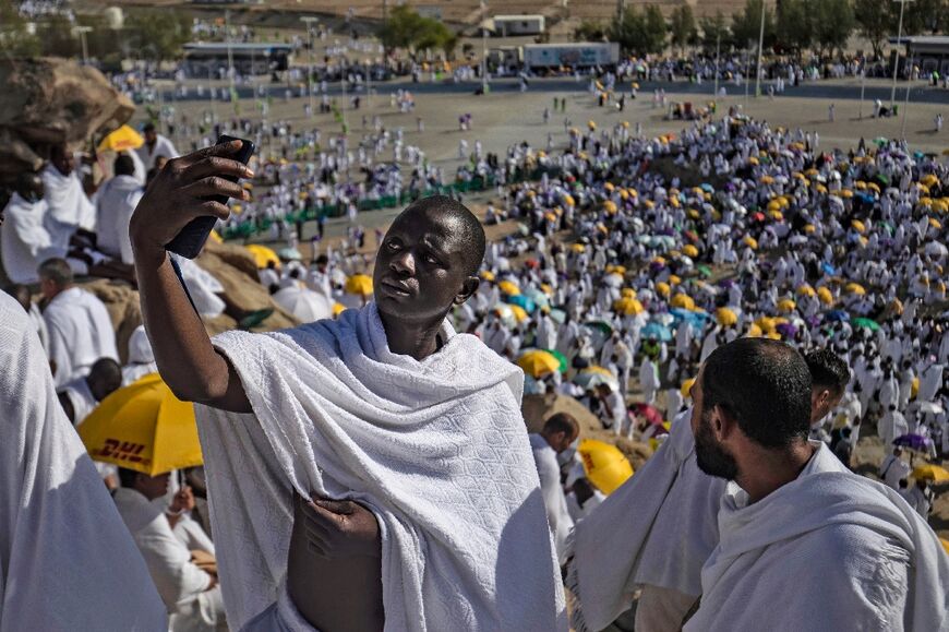 A Muslim pilgrim takes a selfie picture atop Mount Arafat during the hajj pilgrimage in Saudi Arabia