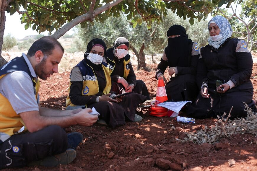 Members of the Syrian civil defence group the White Helmets and volunteers take part in a course on how to locate and neutralise unexploded ordnance 