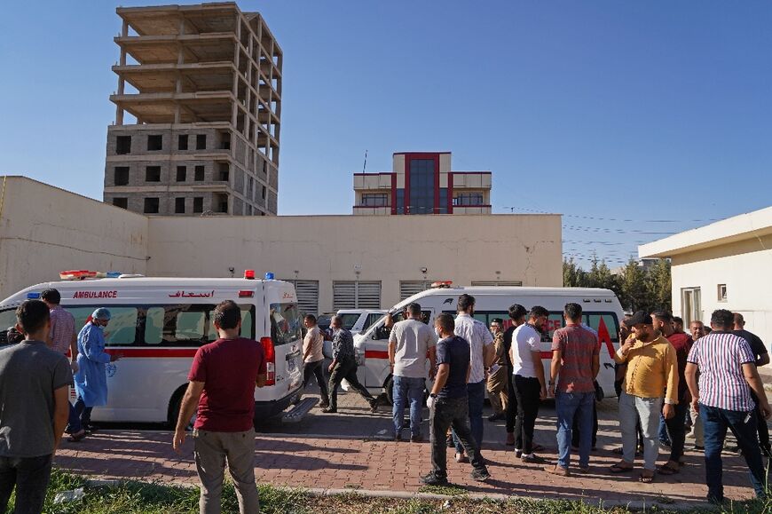 People gather outside a hospital following shelling in the city of Zakho in the north of Iraq's autonomous Kurdish region on July 20