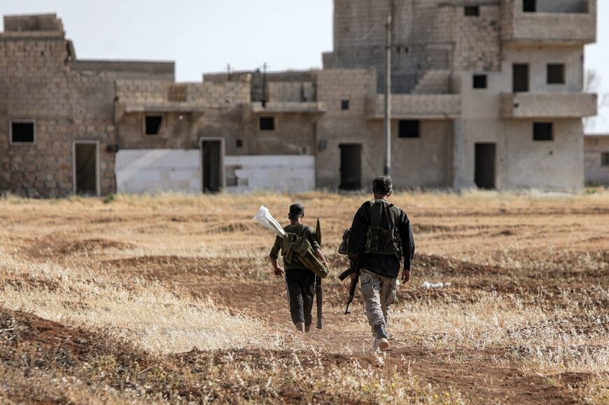 Turkish-backed Syrian rebel fighters are seen near the front lines with the Syrian Democratic Forces (SDF) in the countryside of Syria's northern city of Manbij, on June 8, 2022. Erdogan has threatened to launch a new offensive in northern Syria