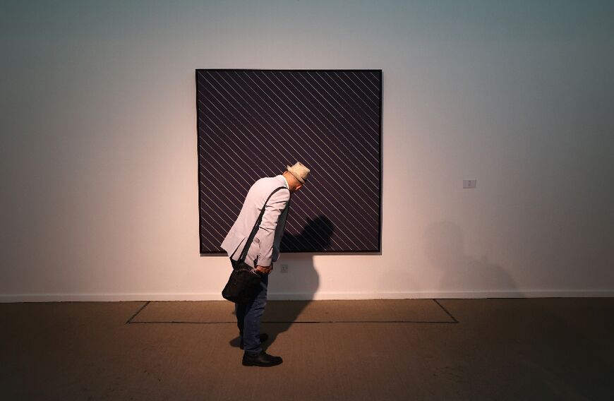 A visitor looks at an installation by American painter Frank Stella: the current "Minimalism and Conceptual Art" exhibition in Tehran features 132 works by 34 world-famous contemporary artists