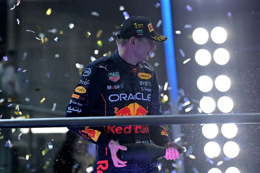 Red Bull's Dutch driver Max Verstappen celebrates on the podium after winning the 2022 Saudi Arabia Formula One Grand Prix at the Jeddah Corniche Circuit on March 27, 2022