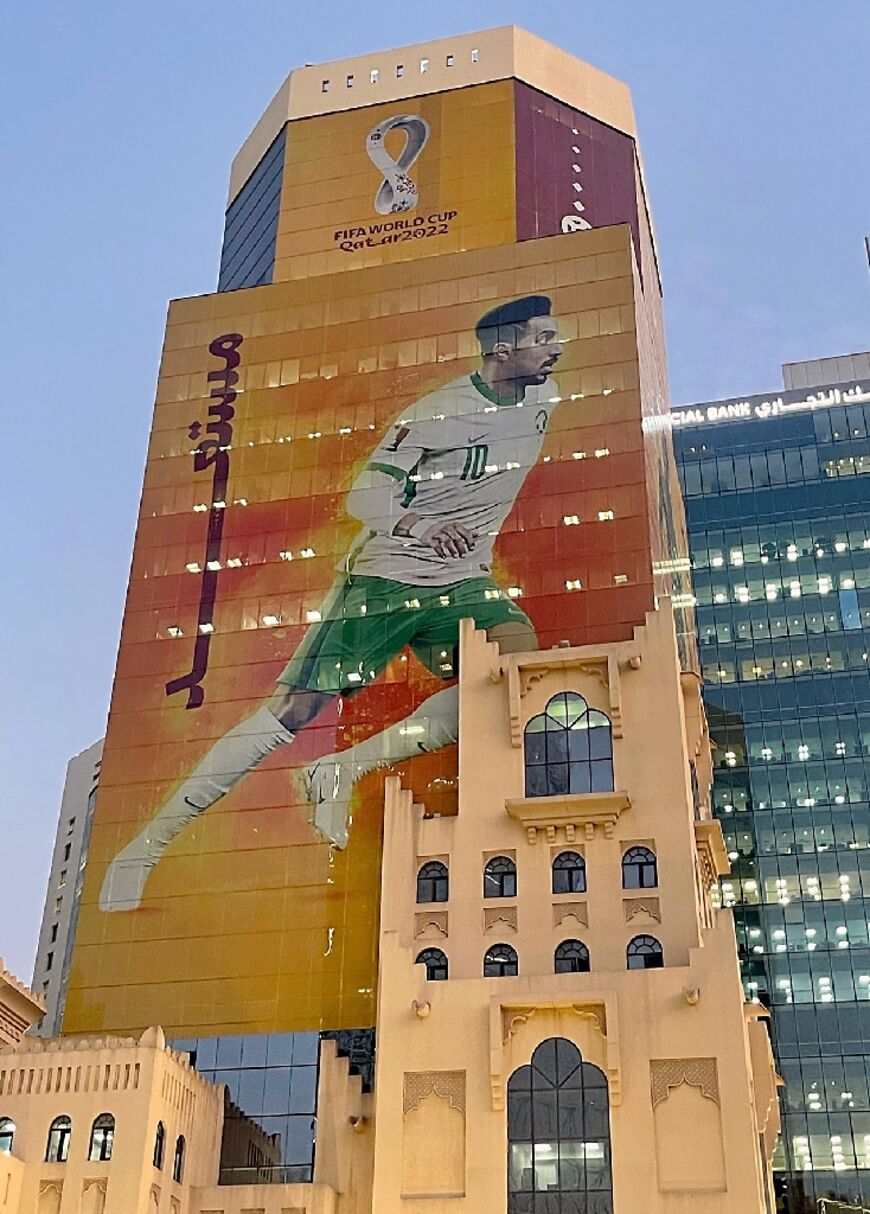 A poster of Saudi Arabia's midfielder Salem al-Dawsari, whose team qualified for the FIFA 2022 World Cup, adorns a building in the Qatari capital Doha