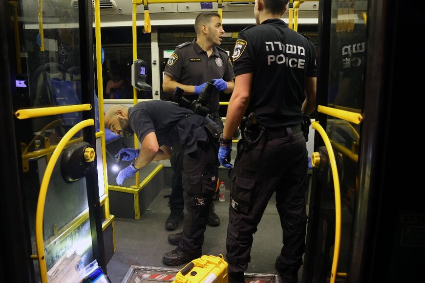 Israeli security inspect the bus after the attack near Jerusalem's Old City
