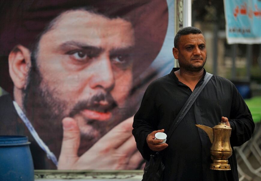 Volunteers distribute food to supporters of Iraqi Shiite cleric Moqtada Sadr during a protest outside the Iraqi parliament in Baghdad's Green Zone on August 16, 2022