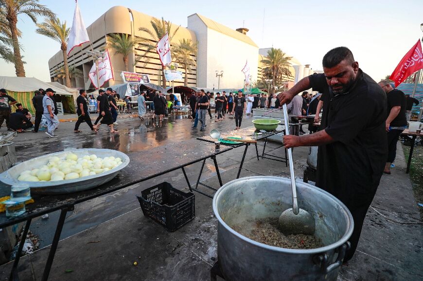 Volunteers prepare food for supporters of Shiite cleric Moqtada Sadr, as they continue to protest against the nomination of a rival Shiite faction for the position of prime minister, outside the Iraqi parliament building in Baghdad's Green Zone