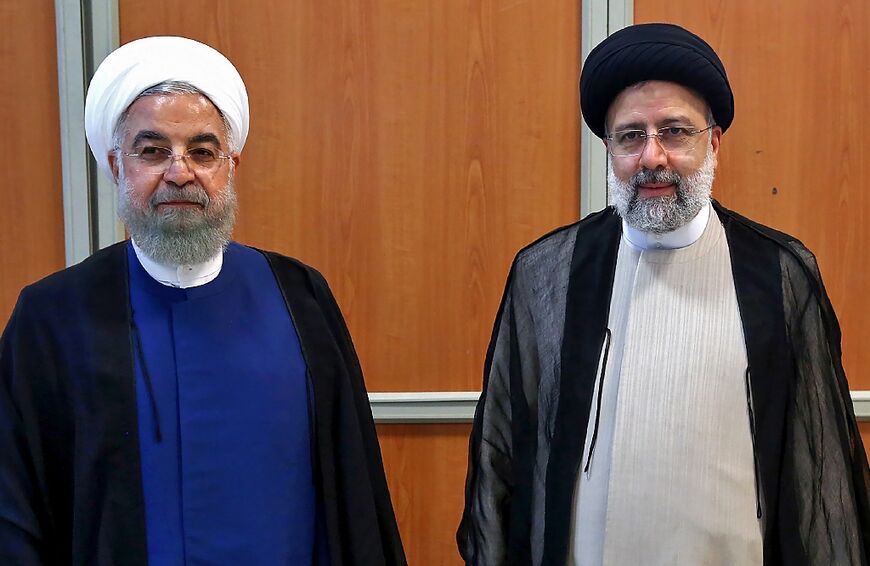 After the 2018-2019 recession, Iran had returned to economic growth under Rouhani, pictured standing on the left next to Raisi in this file photo