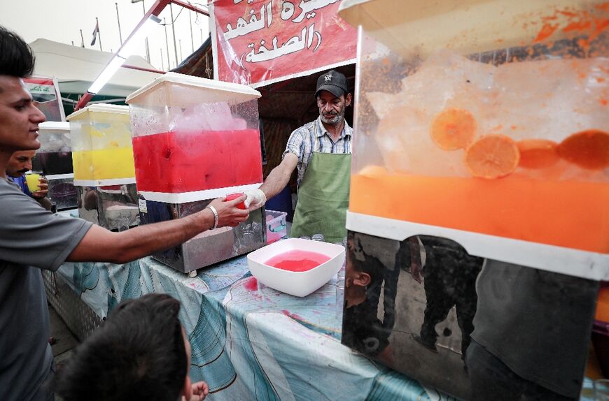 A volunteer serves refreshments to Sadrists at one mawkeb, or stall