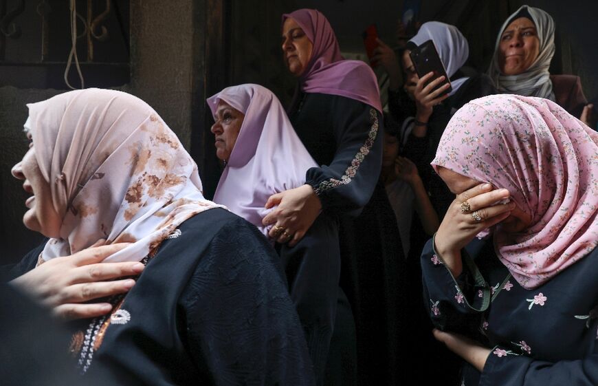 Relatives mourn during the funeral of four teenage Palestinians from the Najm family in Jabalia in the northern Gaza Strip on August 8, 2022, after they were killed during the latest three days of conflict between Israel and Palestinian militants
