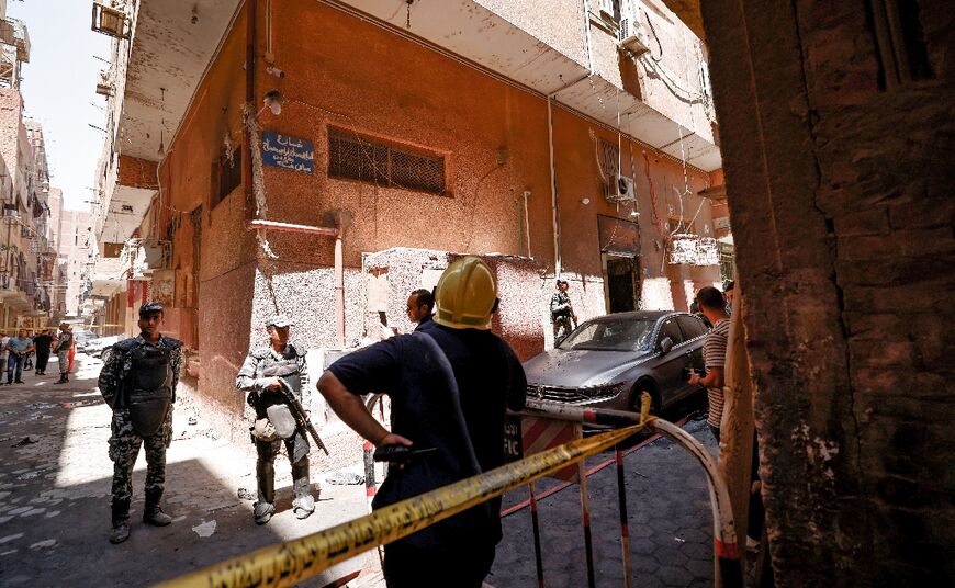 Egyptian police gather outside the Abu Sifin church after the blaze blamed on an electrical fault