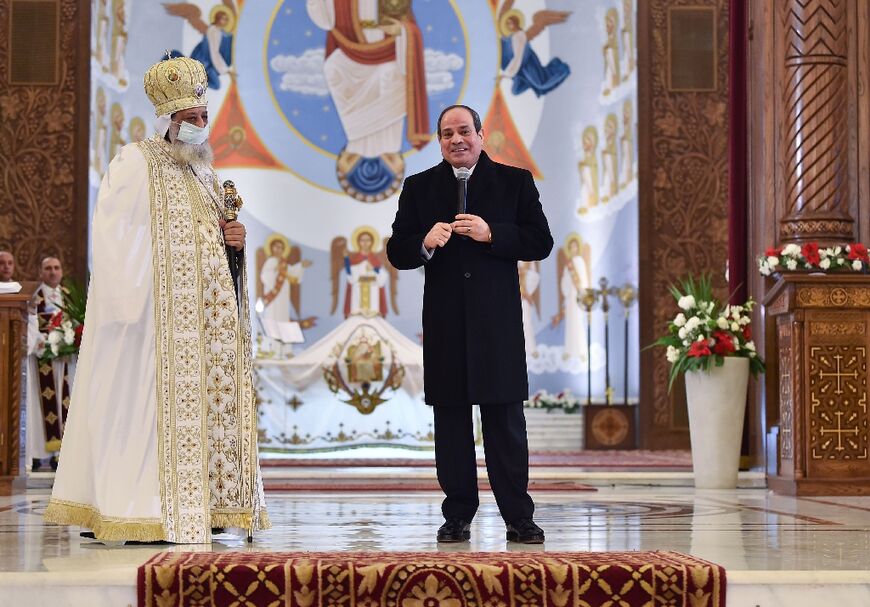 President Abdel Fattah al-Sisi alongside Pope Tawadros II  during a Coptic Orthodox Christmas Eve mass at the Nativity of Christ Cathedral in Egypt's administrative capital east of Cairo on January 6, 2022