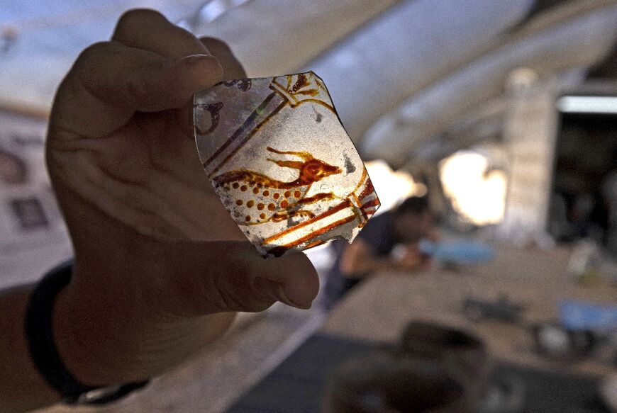 Archaeologist Elena Kogan-Zehavi of the Israel Antiquities Authority displays an artifact recovered from the mansion