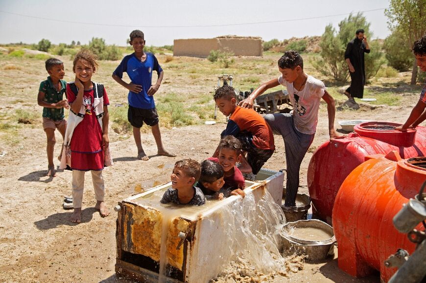 Children in al-Aghawat use a broken fridge to cool down: authorities blame drought for the current water shortages, but also dams built upstream on some rivers and tributaries in neighbouring Turkey and Iran