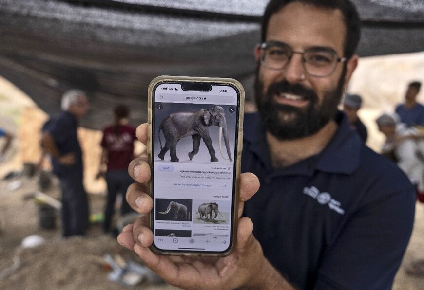 Avi Levy of the Israel Antiquities Authority shows what an ancient straight-tusked elephant (Palaeoloxodon antiquus) would have looked like