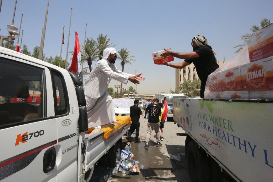 Volunteers distribute water for Sadr supporters who have occupied Iraq's parliament